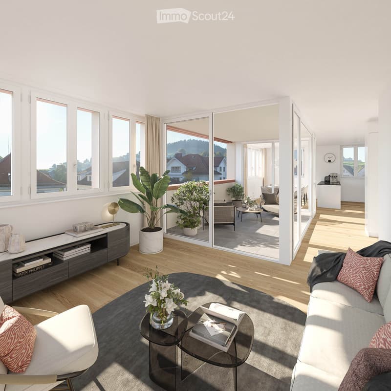 Modern living room with large windows offering a scenic view, featuring a grey sofa, coffee table, side table, bookshelf, and potted plants.