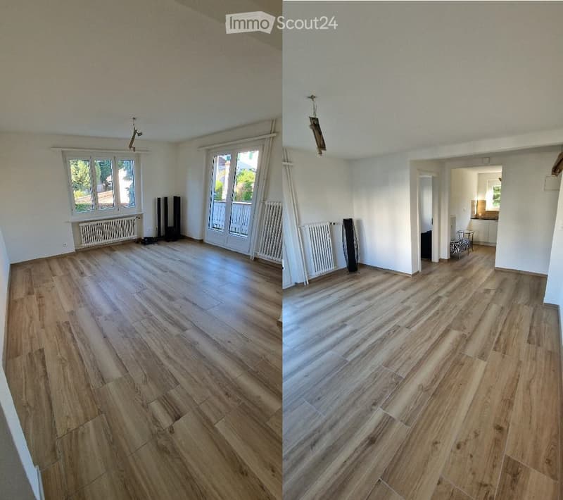 Two unfurnished rooms with wooden flooring, white walls, large windows, and radiators. The left room has a sliding glass door leading to a balcony, while the right room has an open doorway to another area.