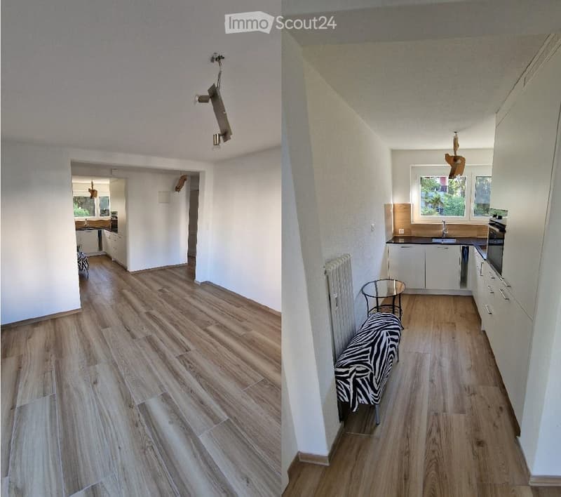 The image shows a modern, well-lit hallway with wooden flooring and white walls. A small table with a zebra-patterned stool is placed near the wall, and a radiator is visible. The hallway leads to a kitchen area with white cabinets, a sink, and a window o