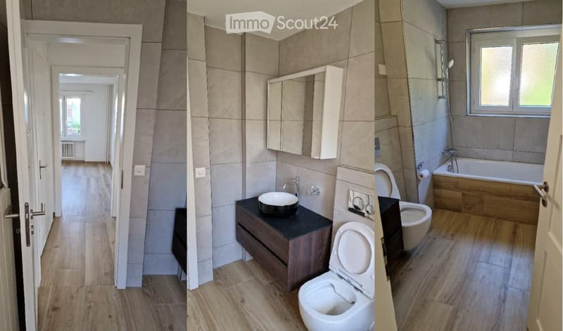 Modern bathroom with a sink, toilet, bathtub, and mirror. The space features light-colored tiles and wooden flooring.