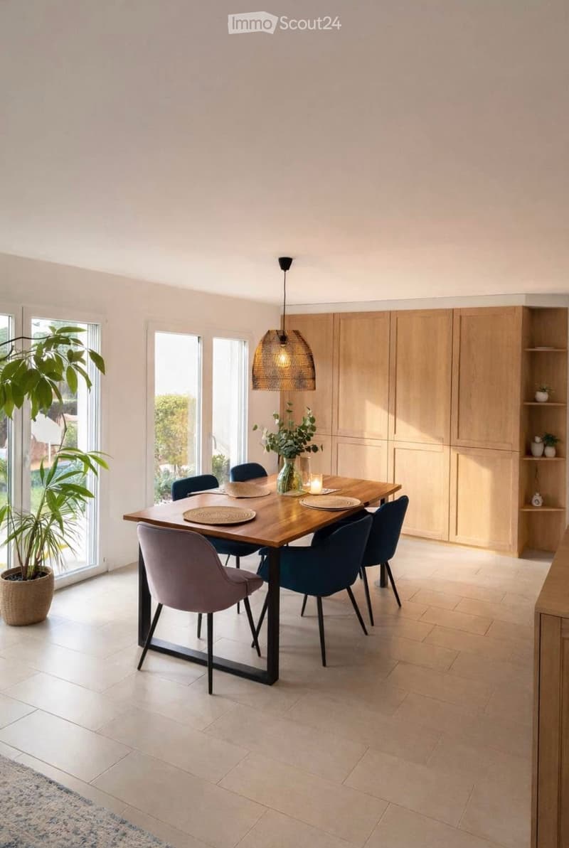 Modern dining room with a wooden dining table, six chairs, pendant light, and built-in cabinets. Features large windows and a potted plant near the window.