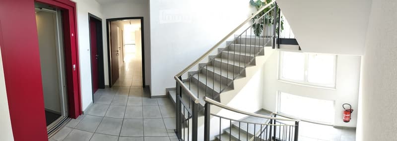 tiled floor, red door, white walls, staircase, fire extinguisher