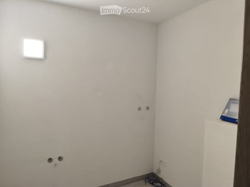 empty room, white walls, ceiling light, electrical outlets, small table
