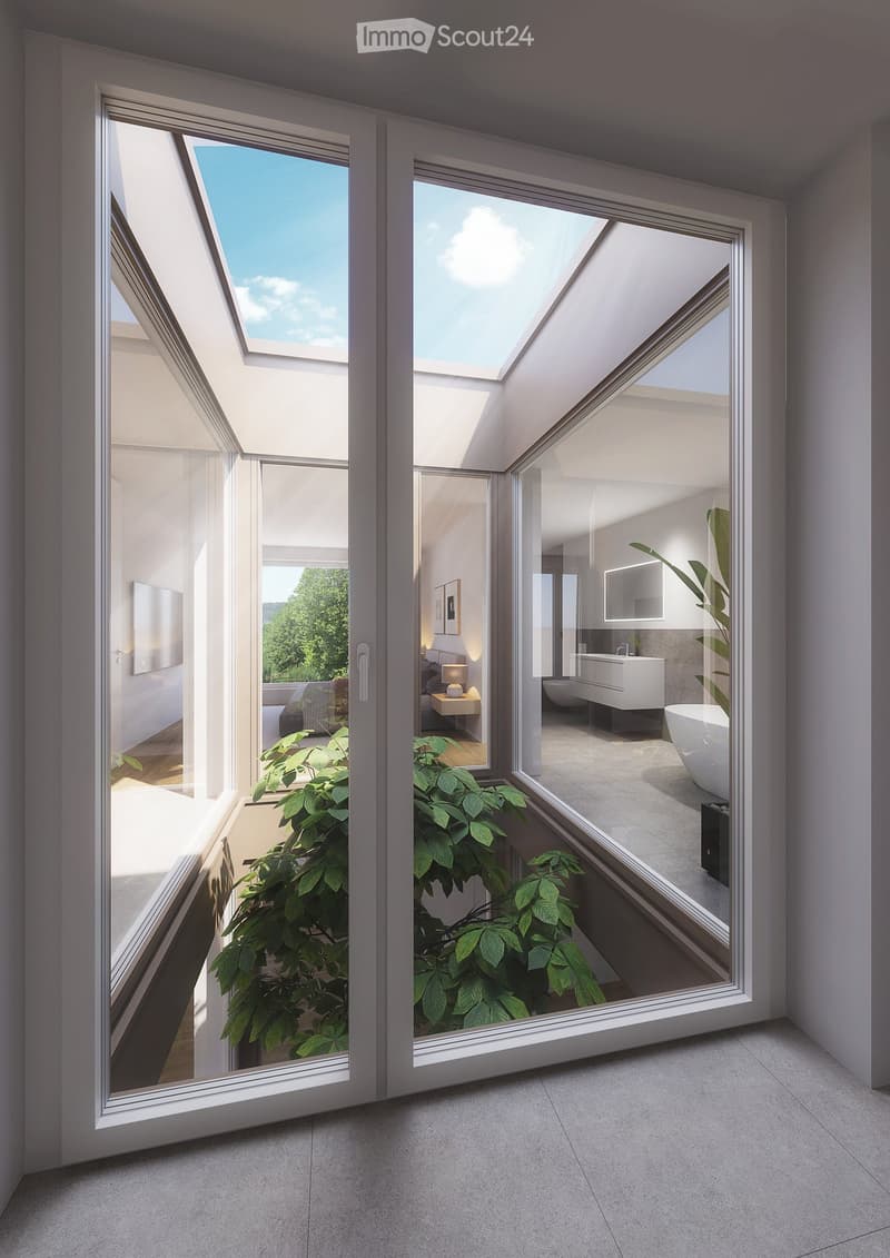 Modern hallway with large glass doors leading to a bedroom and bathroom, featuring a plant in the foreground and a view of greenery outside.
