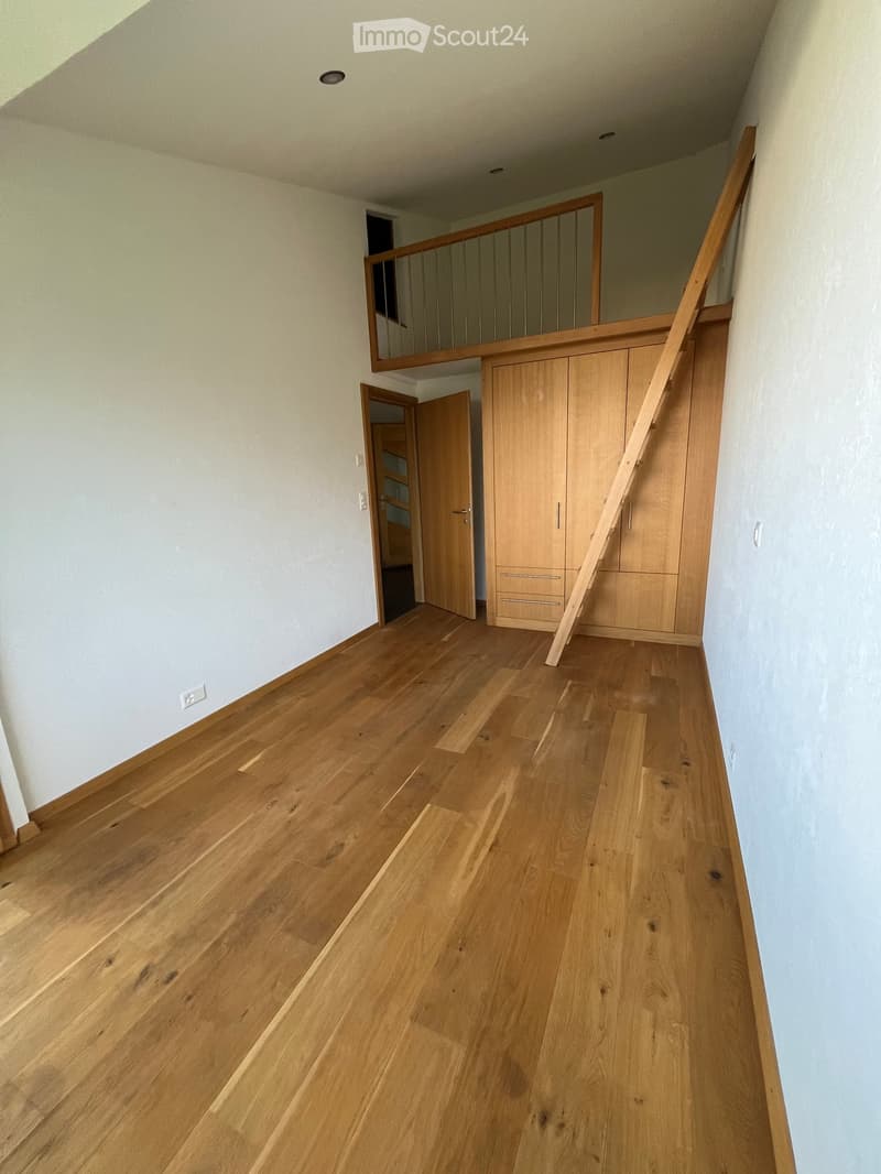 empty room, wooden floors, tall ceilings, wooden built-in wardrobes, open door to the balcony