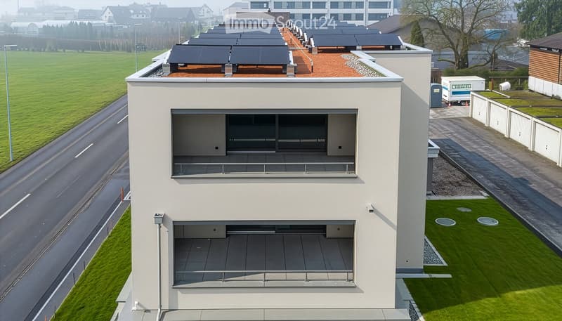 Modern house with solar panels on the roof, multiple terraces, raised ground floor