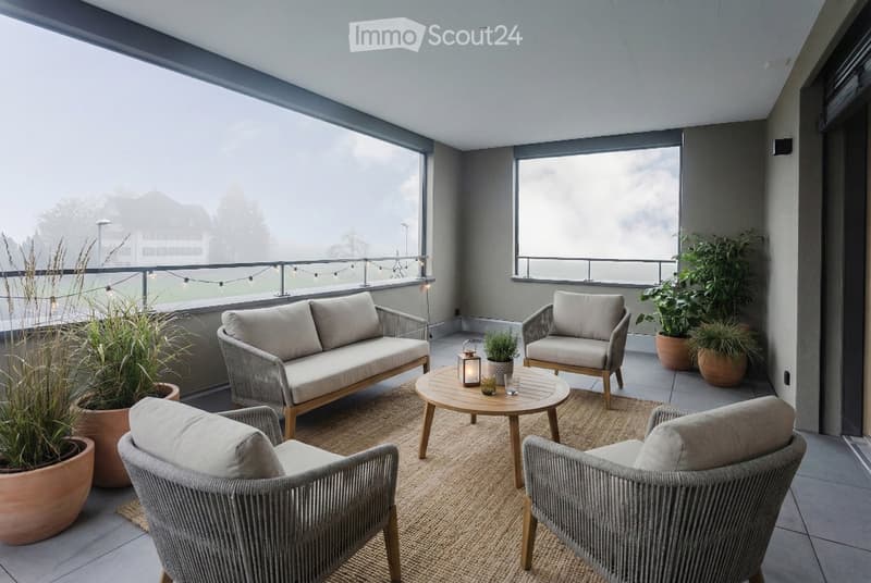 terrace, balcony with large windows, four chairs, sofa, coffee table, lamp, plants