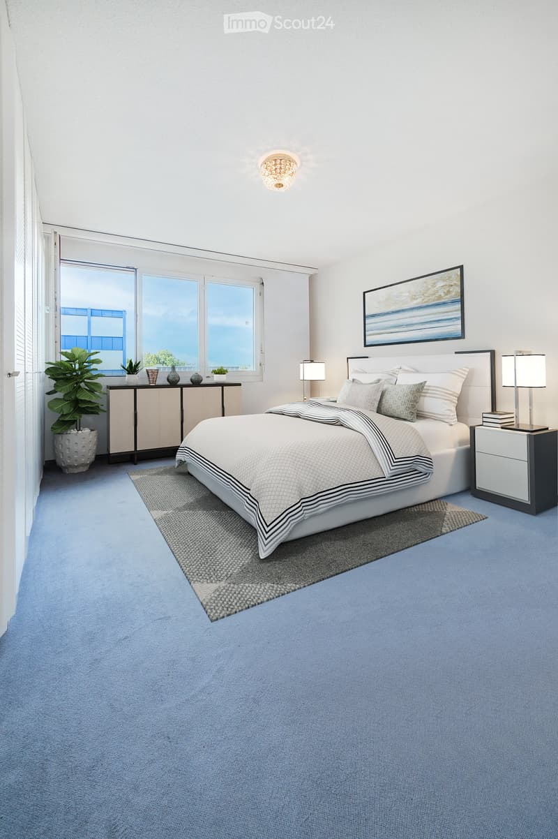 Modern bedroom with a large bed, nightstands, lamps, a sideboard, and a plant near the window.