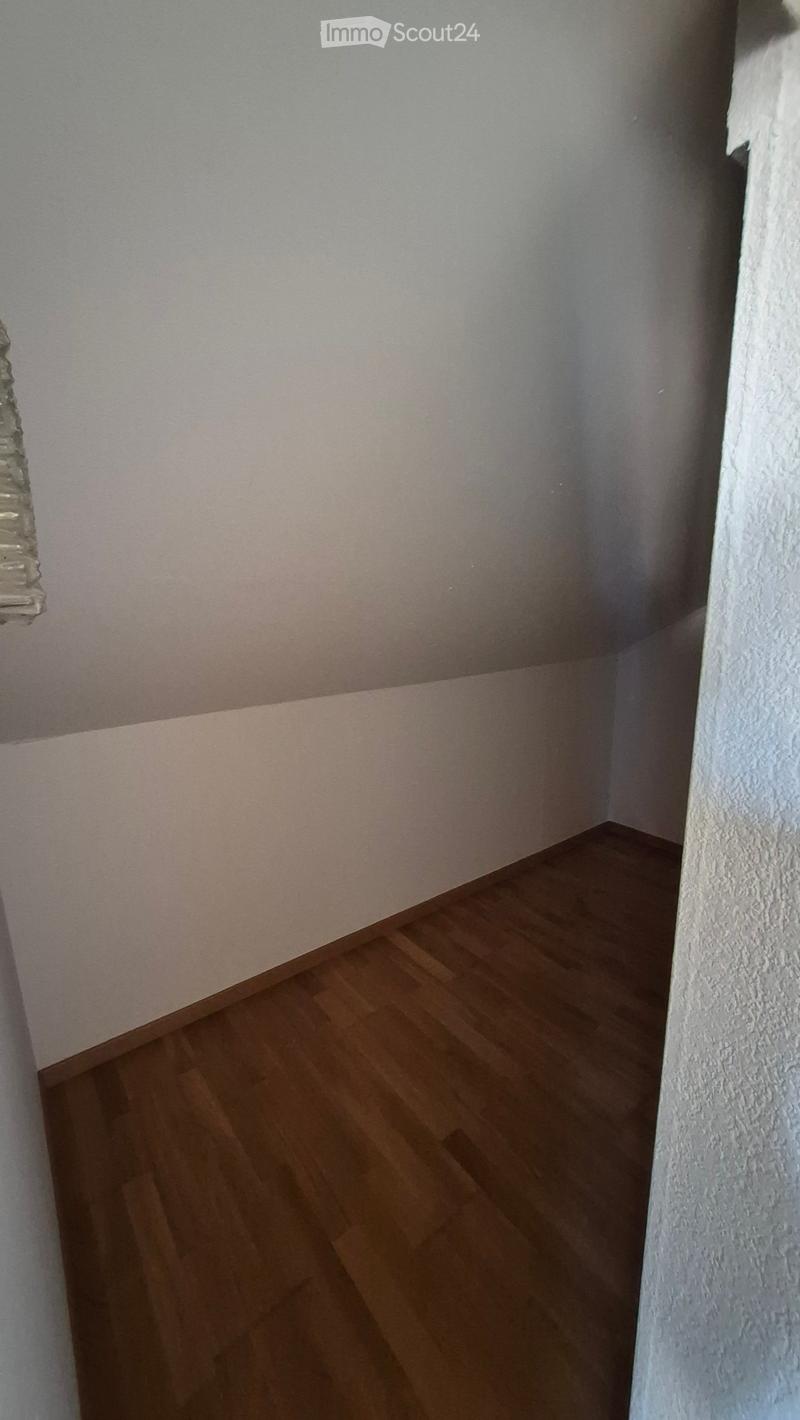Empty room with wooden flooring and white walls, no furniture or equipment present.
