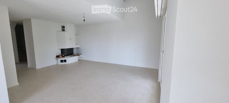 Empty room with white walls, tiled floor, and a small built-in fireplace area with shelves.