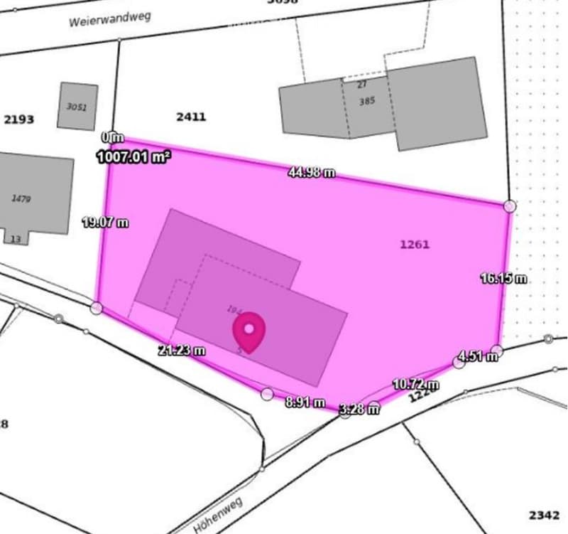 Plot map showing a property with dimensions and surrounding land plots. The main plot is highlighted in pink with measurements in meters.