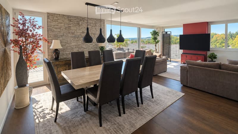 Modern open-concept living and dining area with a stone accent wall, large windows, a dining table with six chairs, a sofa, a television, and decorative vases.