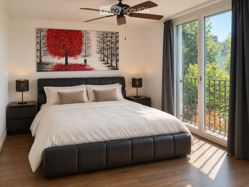 Modern bedroom with a large bed, nightstands, lamps, and a large picture frame on the wall. The room has large windows with a view of greenery outside.