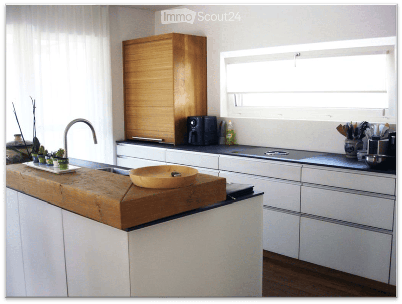 {"type": "Kitchen", "objects": ["wooden cutting board", "wooden bowl", "faucet", "sink", "coffee maker", "kitchen cabinets", "kitchen drawers", "kitchen counter", "kitchen utensils", "kitchen tools", "kitchen appliances", "kitchen sink", "kitchen sink fau