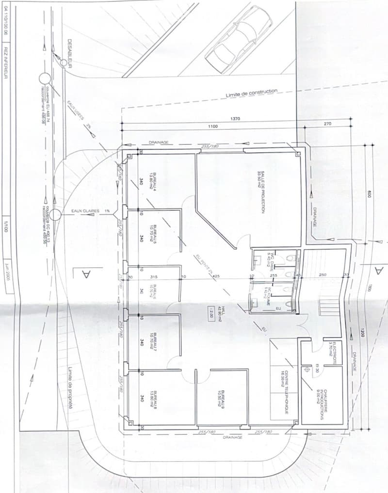 Floor plan showing a layout with multiple rooms including a living room, kitchen, bedrooms, bathrooms, and a parking area.