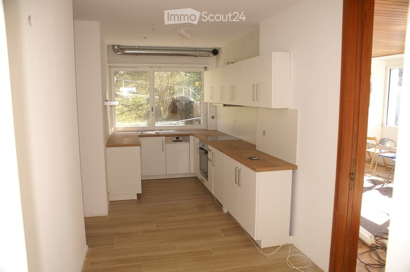 {"visible_features": ["Private washing machine", "Dishwasher"],    "type": "Room",    "description": "Open plan kitchen with large window, wooden floor, white appliances including dishwasher, electric stove, wooden countertops, white cabinets",    "loc