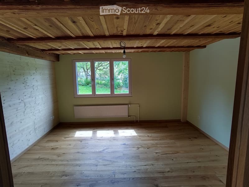 Unfurnished Room. Empty room with wooden ceiling, wooden floor, and a window with a view of trees outside.