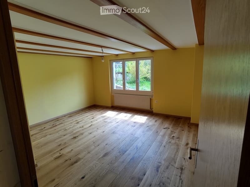 Unfurnished Room. Empty room with wooden floor, yellow walls, and a window with a white radiator below.