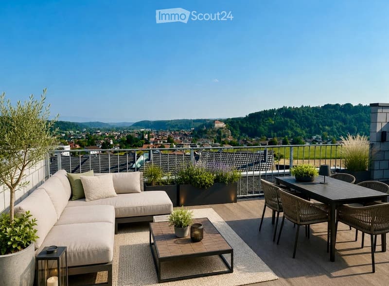 A modern rooftop terrace with a panoramic city view, featuring a cream-colored sofa, a small coffee table, a dining table with four chairs, and several potted plants.