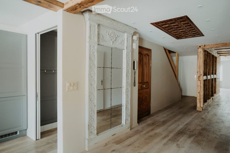wooden ceiling, decorative mirror, wooden floor, telephone on the wall