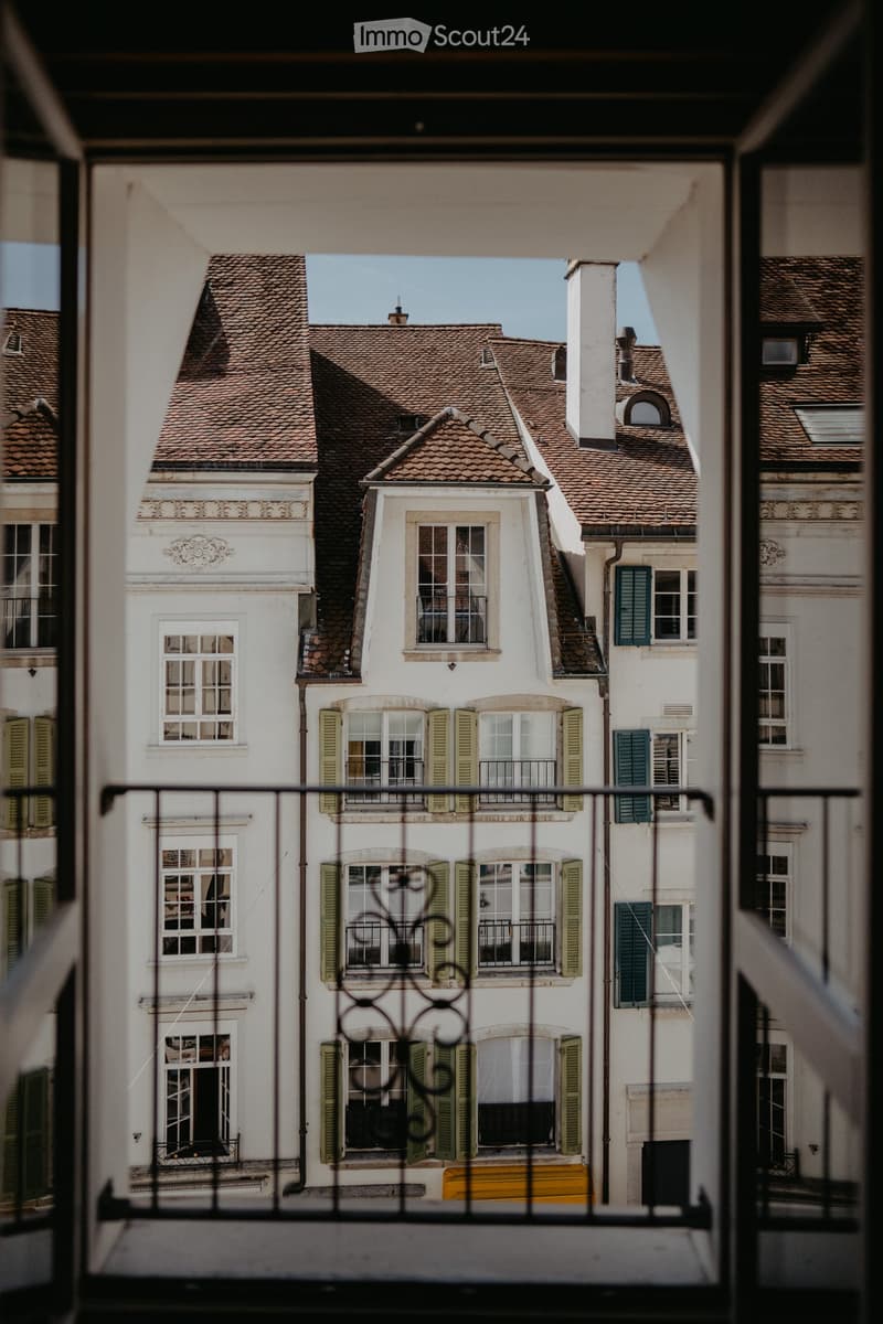 Balcony with view to a street and neighbouring buildings