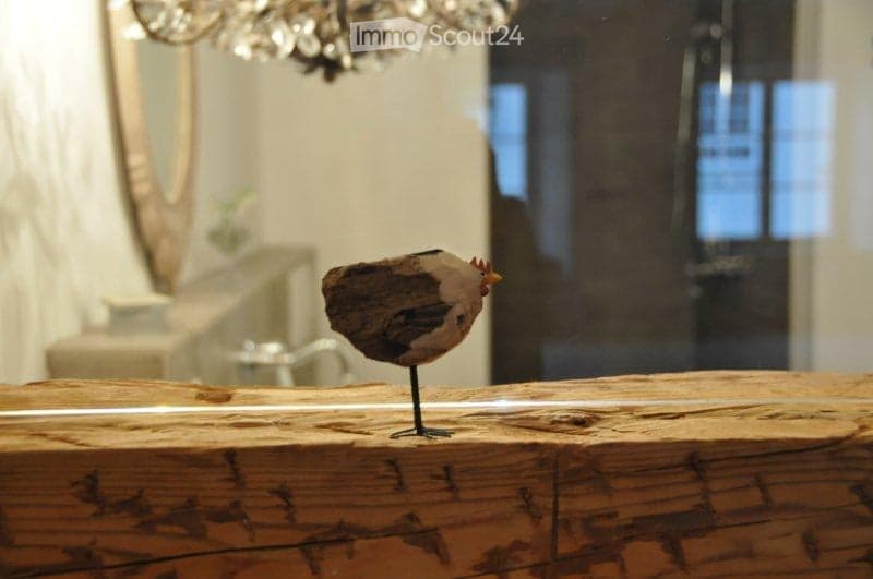 Close up of a decorative wooden chicken statue in the middle of the countertop