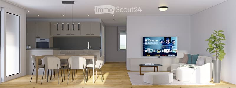 Modern open-plan living and dining area with a white sofa, ottoman, coffee table, dining table with chairs, and a large television. The kitchen features grey cabinets and an oven.