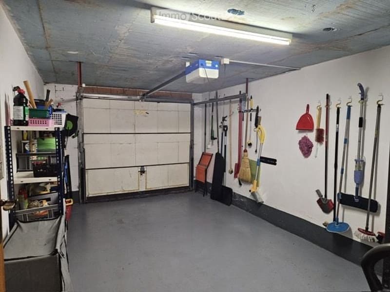 {"visible_features": ["Garage"], "type": "Garage", "objects": [], "description": "Clean, organized garage with a large roll-up door, shelves, and various cleaning tools and equipment neatly stored.", "localized_descriptions": {"EN": "Clean, organized gara