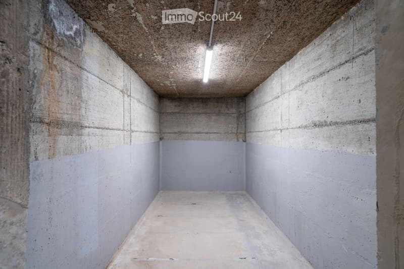 Empty concrete room with bare walls, ceiling, and floor. No furniture or equipment visible.