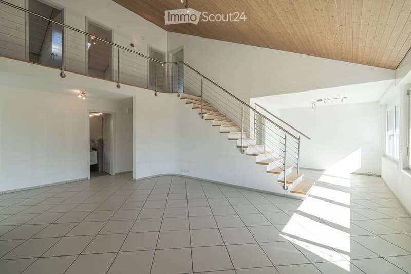 Open, modern hallway with a staircase leading to an upper level, white tiled floor, white walls, wooden ceiling, and a metal railing.