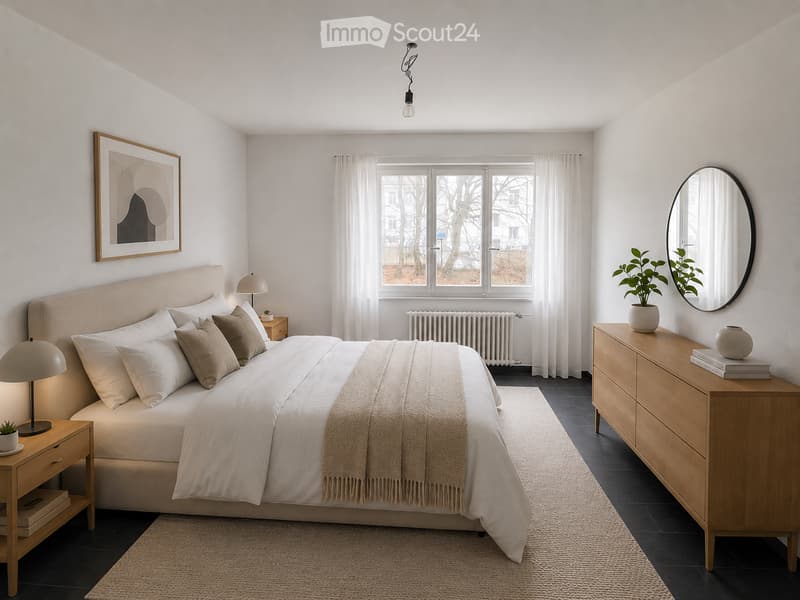 Modern bedroom with a large bed, nightstands, lamps, a dresser, and a mirror. The room features a large window with white curtains and a view of trees outside.
