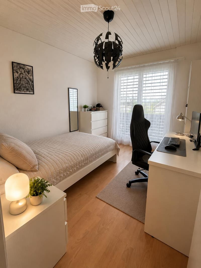 Modern bedroom with a bed, desk, chair, and nightstand. Features a large window with blinds, a hanging lamp, and a potted plant on the nightstand.