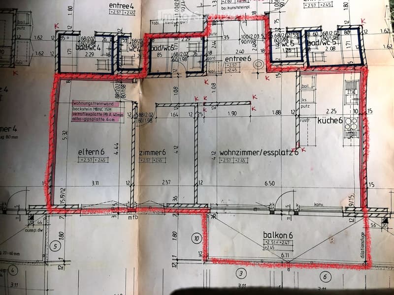 Floor plan showing multiple rooms including entrances, bathrooms, kitchen, living room, bedrooms, and a balcony.