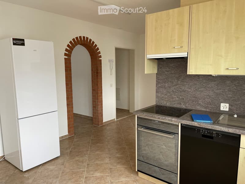 large fridge, built-in oven, dishwasher, tile flooring, countertop with power outlet, archway entrance