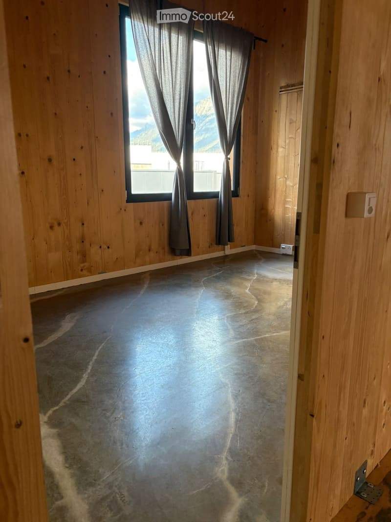 empty room, wooden walls, gray marble flooring, large window, curtains