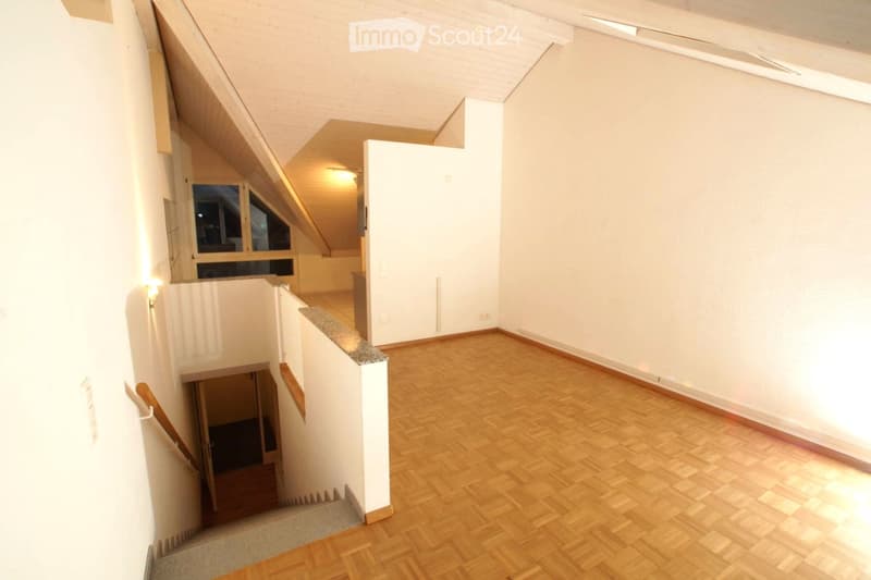 wooden parquet floor, white walls, stairs, windows in the attic, small balcony