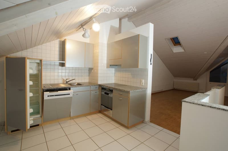 Slanted ceilings, modern fitted kitchen, under cabinet lighting, dishwasher, refrigerator, gas stove