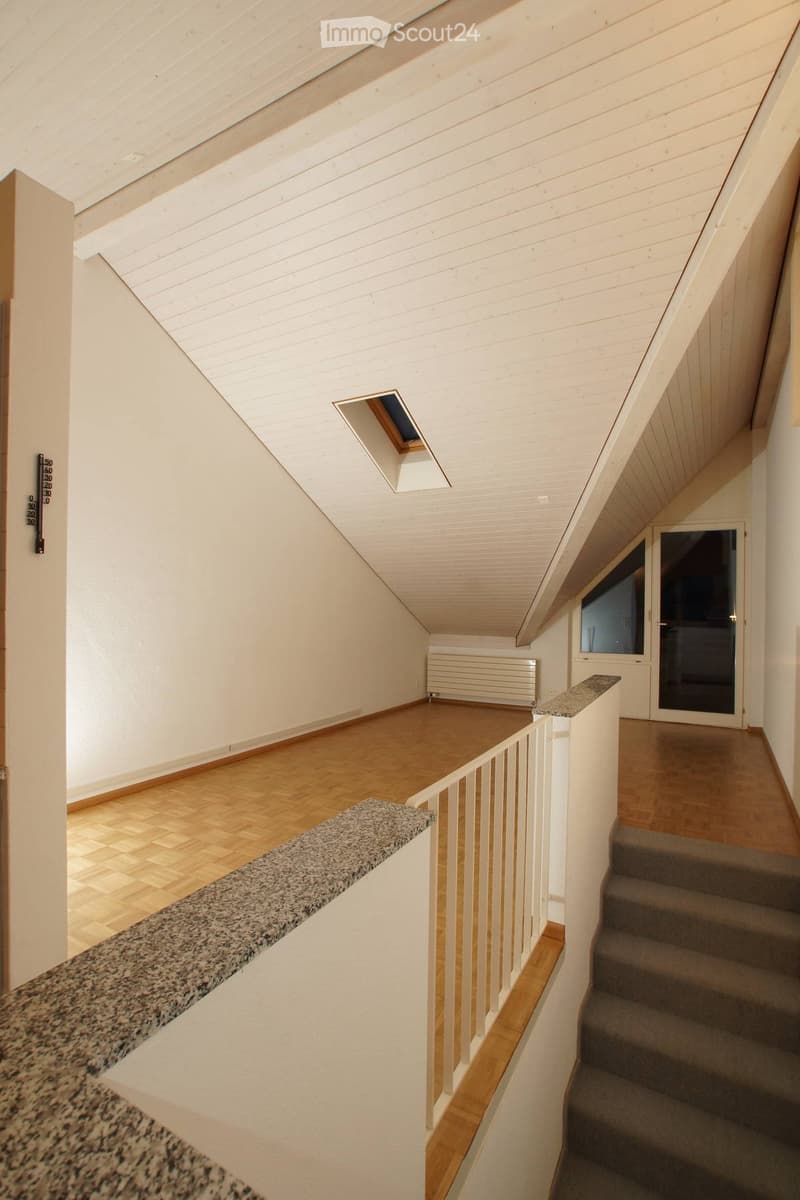 {"visible_features": [], "type": "Stairwell", "description": "open stairs, wooden flooring, carpeted steps, ceiling with skylight, exposed wooden beams"}