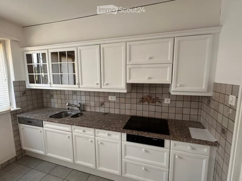 Modern kitchen with white cabinets, granite countertops, a sink, a dishwasher, and an electric stove.