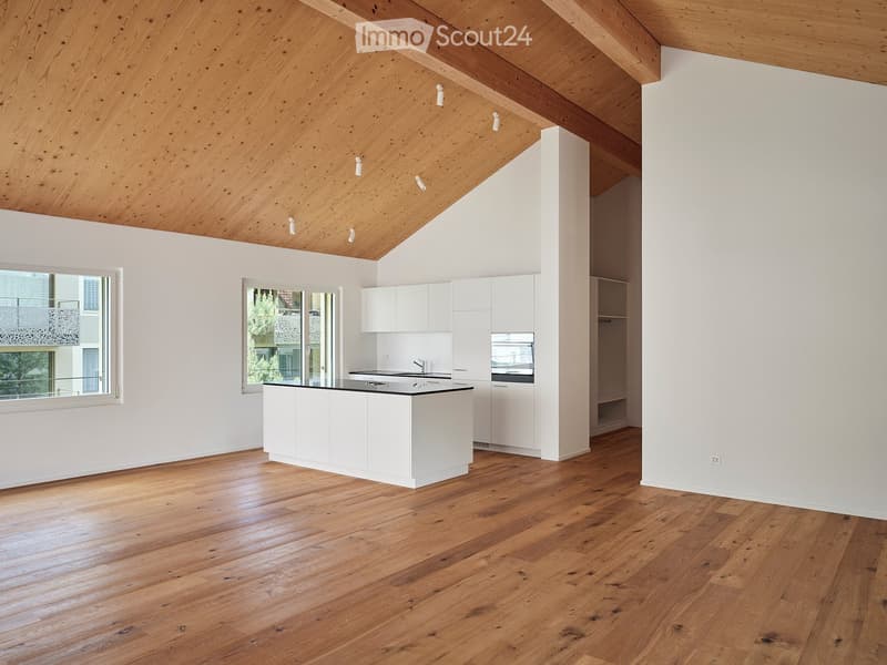 Kitchen. Modern kitchen with white cabinets, a central island, and wooden flooring. Features large windows and a sleek design.