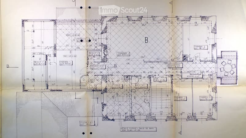 Architectural floor plan showing multiple rooms including bedrooms, bathrooms, kitchen, and living areas with labeled dimensions and room names.