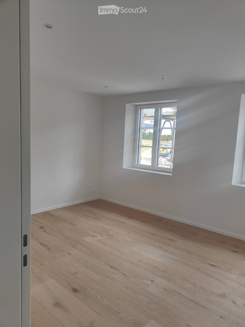 empty room, white walls, wooden floor, two windows, no furniture