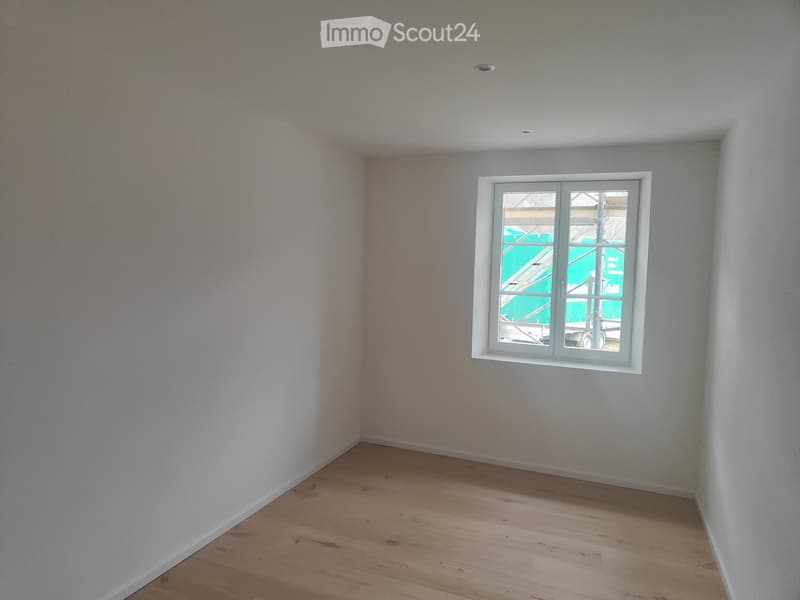 Empty room with wooden floor and a single window