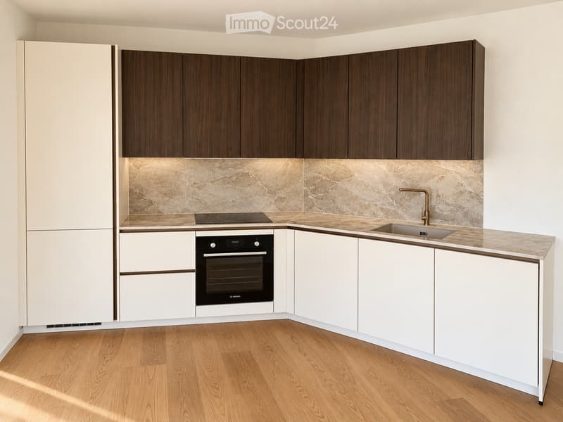 Modern kitchen with white and dark wood cabinets, marble backsplash, wooden flooring, and built-in appliances including an oven, induction cooktop, and sink with a modern faucet.
