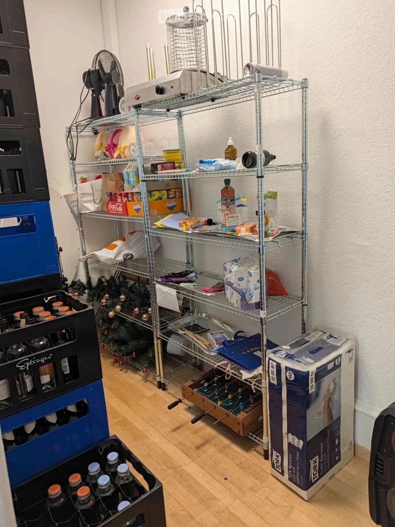 {"visible_features": [], "type": "Furnished Room", "objects": ["shelf", "fan", "cage", "bottle", "bottle", "bottle", "bottle", "bottle", "bottle", "bottle", "bottle", "bottle", "bottle", "bottle", "bottle", "bottle", "bottle", "bottle", "bottle", "bottle"