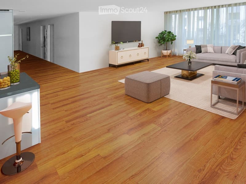 Modern living room with hardwood flooring, grey sofa, coffee table, ottoman, side table, television, and decorative plants.