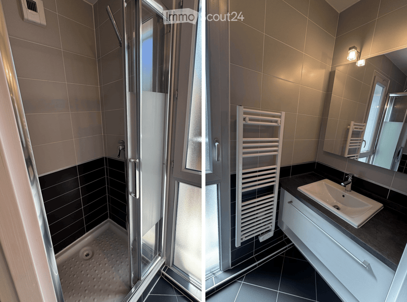 Modern bathroom with a glass-enclosed shower stall and a sink with a mirror and radiator.