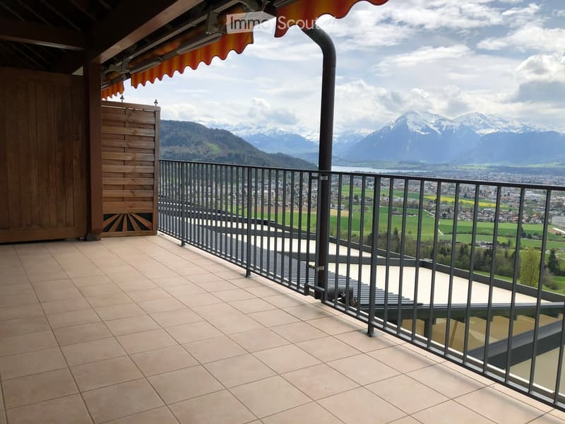 Balcony with tiled floor, metal railing, and scenic mountain view.