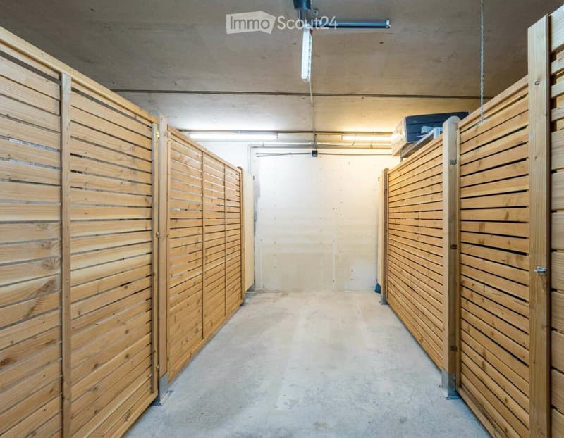 Empty room with wooden partitions and concrete floor, no furniture or equipment.