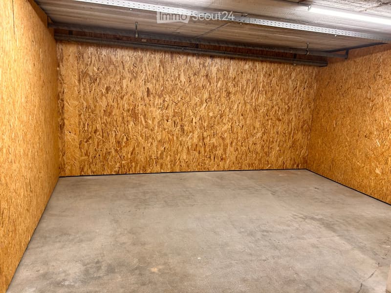 Empty room with wooden walls and a concrete floor, no furniture or equipment.